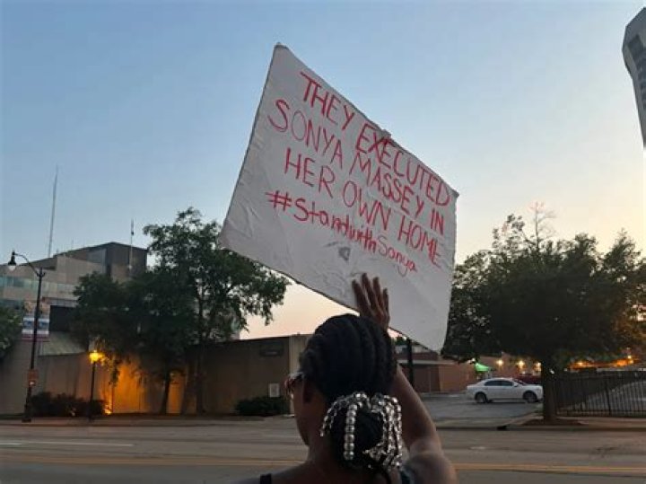 A protester makes a statement on a face mask