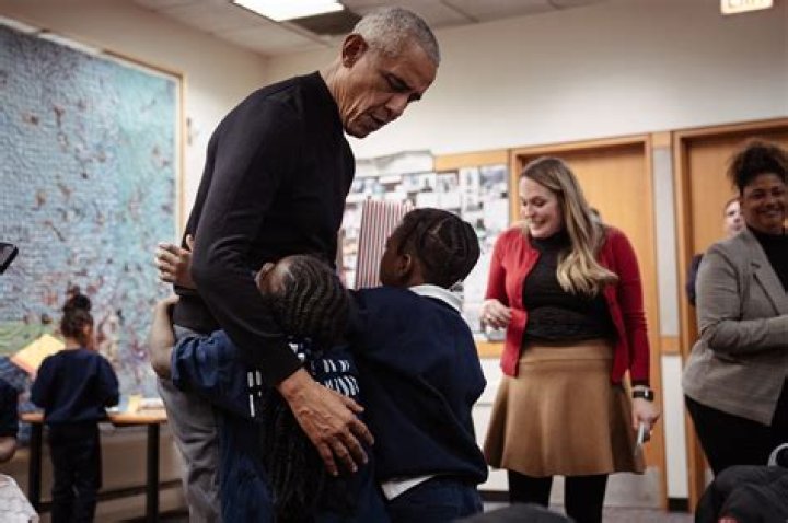 Barack Obama gets a supportive hug from his wife Michelle