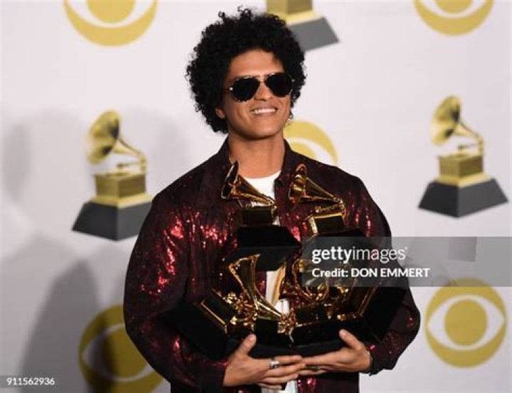 Bruno Mars poses in the press room with his awards for best R&B album, record of the year, album of the year, best engineered album, non-classical, for "24K Magic," and song of the year, best R&B performance and best R&B song, for "That's What I Like" at the 60th annual Grammy Awards at Madison Square Garden, in New York 60th Annual Grammy Awards - Press Room, New York, USA - 28 Jan 2018