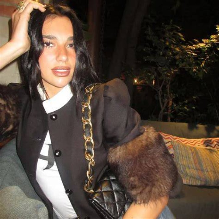 EXCLUSIVE: Singer Dua Lipa wears a hot pink bikini as she relaxes by the pool with a mystery man in Miami. 06 Feb 2022 Pictured: Dua Lipa. Photo credit: Backgrid/MEGA TheMegaAgency.com +1 888 505 6342 (Mega Agency TagID: MEGA826065_022.jpg) [Photo via Mega Agency]